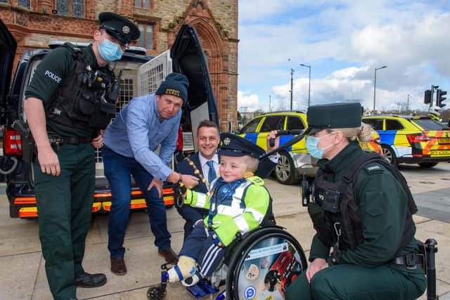 Jack Beattie from Donegal who has Osteogenesis Imperfacta or Brittle Bone Disease pictured during a reception held for him by Alderman Graham Warke, Mayor of Derry City and Strabane District Council. The honorary Garda also met with members of the PSNI who presented him with a certificate of recognition and the PSNI crest. Jack also made his first arrest in the North when he put the handcuffs on his dad Kevin.  Picture Martin McKeown. 30.03.22