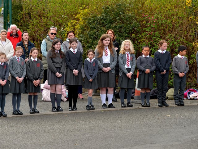 Local schools form a guard of honour outside Holy Family Church after Requiem Mass for Fr Paddy OKane on Thursday afternoon. Photograph: George Sweeney / Derry Journal. DER2213GS 040