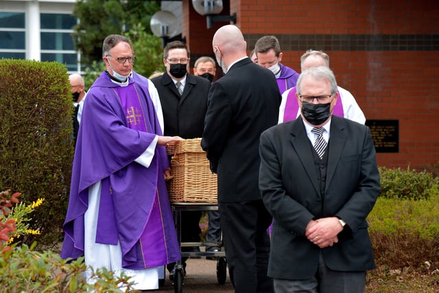 The coffin of Fr Paddy OKane is taken to a hearse for burial in Culdaff after Requiem Mass in Holy Family Church, Ballymagroarty, on Thursday afternoon. Photograph: George Sweeney / Derry Journal. DER2213GS  035