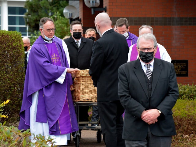 The coffin of Fr Paddy OKane is taken to a hearse for burial in Culdaff after Requiem Mass in Holy Family Church, Ballymagroarty, on Thursday afternoon. Photograph: George Sweeney / Derry Journal. DER2213GS 035