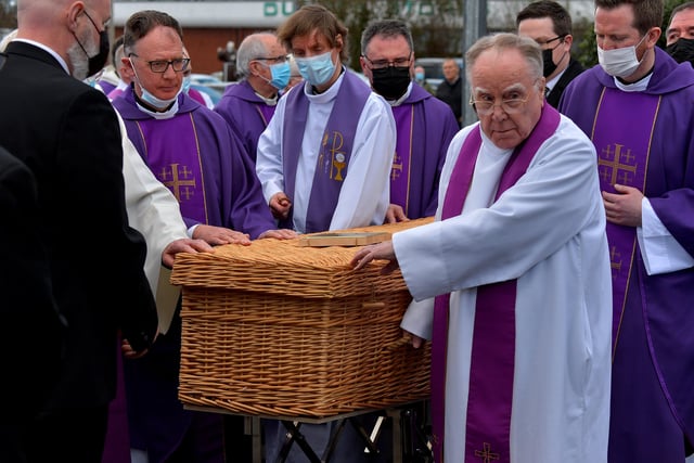 The coffin of Fr Paddy OKane is taken to a hearse for burial in Culdaff after Requiem Mass in Holy Family Church, Ballymagroarty, on Thursday afternoon. Photograph: George Sweeney / Derry Journal. DER2213GS  036