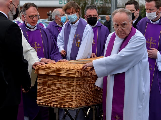 The coffin of Fr Paddy OKane is taken to a hearse for burial in Culdaff after Requiem Mass in Holy Family Church, Ballymagroarty, on Thursday afternoon. Photograph: George Sweeney / Derry Journal. DER2213GS 036
