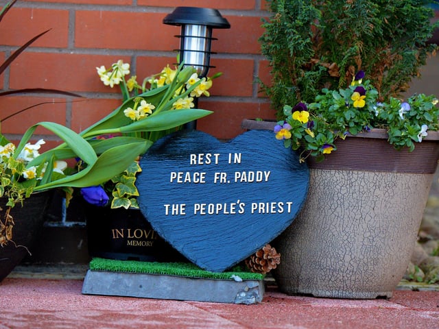 A memorial to Fr Paddy OKane, placed outside Holy Family Church by a parishioner. Photograph: George Sweeney / Derry Journal. DER2213GS 044