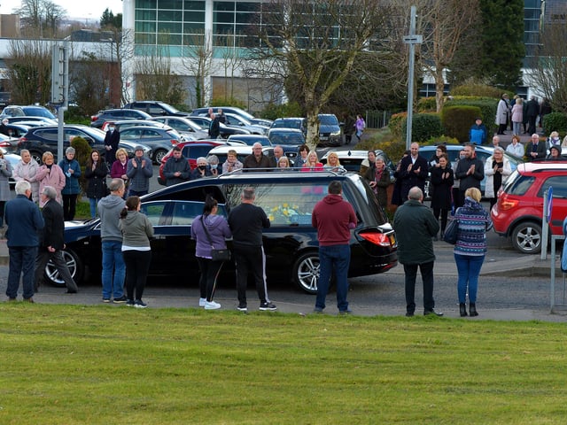 People applaud as the the hearse carrying the remains of Fr Paddy OKane leaves Holy Family Church on Thursday afternoon. Photograph: George Sweeney / Derry Journal. DER2213GS 042