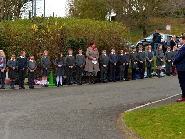 Local schools form a guard of honour outside Holy Family Church after Requiem Mass for Fr Paddy OKane on Thursday afternoon. Photograph: George Sweeney / Derry Journal. DER2213GS 039