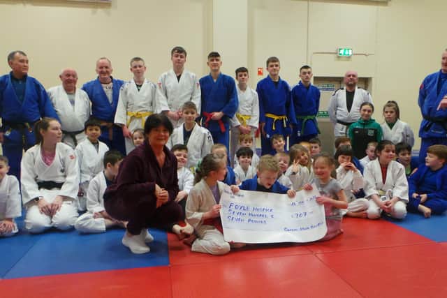 Members of Samurai Judo Club handing over the cheque to Margaret Burns, Foyle Hospice.