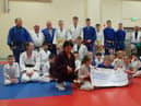 Members of Samurai Judo Club handing over the cheque to Margaret Burns, Foyle Hospice.