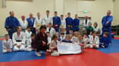 Members of Samurai Judo Club handing over the cheque to Margaret Burns, Foyle Hospice.