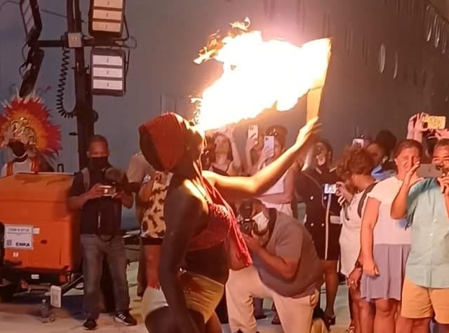 A fire-eater entertains passengers in Nassau.