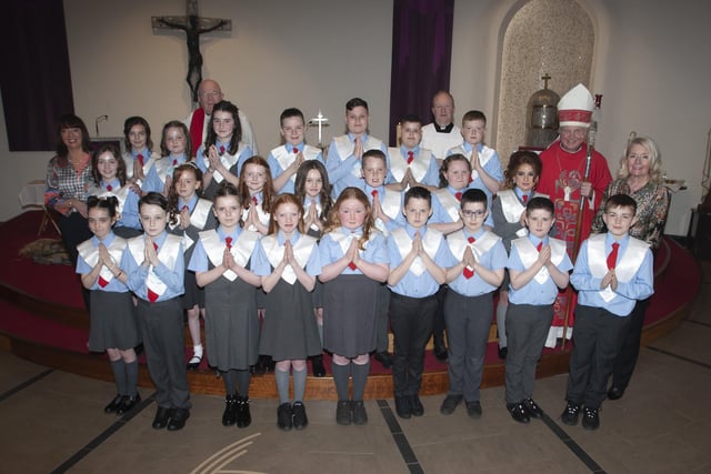 Children from St. Brigidâ€TMs Primary School, Carnhill pictured after receiving the Sacrament of Confirmation from Bishop Donal McKeown at St. Brigidâ€TMs Church on Wednesday afternoon last. Included in photo are Fr. Gerard Mongan CC and Fr. Michael McCaughey, PP, Ms. Mary McCallion, Principal, St. Brigidâ€TMs PS and teacher Mrs. Jennifer McDaid. (Photo: Jim McCafferty Photography)