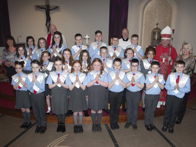 Children from St. Brigidâ€TMs Primary School, Carnhill pictured after receiving the Sacrament of Confirmation from Bishop Donal McKeown at St. Brigidâ€TMs Church on Wednesday afternoon last. Included in photo are Fr. Gerard Mongan CC and Fr. Michael McCaughey, PP, Ms. Mary McCallion, Principal, St. Brigidâ€TMs PS and teacher Mrs. Jennifer McDaid. (Photo: Jim McCafferty Photography)