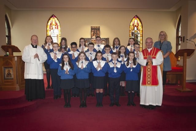 CONFIRMATION. . . . . .Pupils from St. Paulâ€TMs Primary School, Slievemore pictured after receiving the Sacrament of Confirmation from Fr. Noel McDermott at St. Josephâ€TMs Church, Galliagh on Monday afternoon. Included are Fr. Gerard Mongan and Ms. Claire McGinty, class teacher. (Photo: Jim McCafferty Photography)