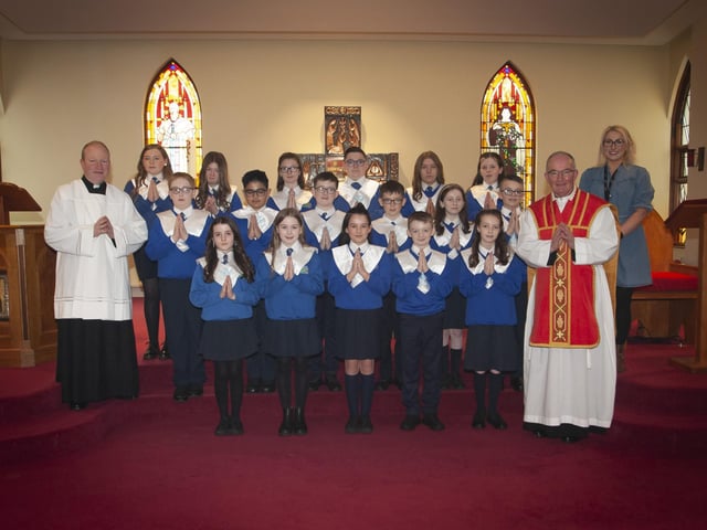 CONFIRMATION. . . . . .Pupils from St. Paulâ€TMs Primary School, Slievemore pictured after receiving the Sacrament of Confirmation from Fr. Noel McDermott at St. Josephâ€TMs Church, Galliagh on Monday afternoon. Included are Fr. Gerard Mongan and Ms. Claire McGinty, class teacher. (Photo: Jim McCafferty Photography)