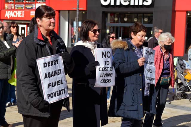 People hold posters at the Derry Fuel Poverty Rally in Waterloo Place on Sunday afternoon last. Photo: George Sweeney.  DER2213GS – 071