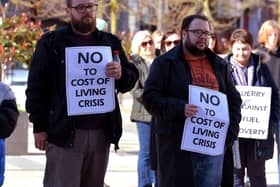 Colr. Doyle and other people hold posters at the Derry Fuel Poverty Rally in Waterloo Place on Sunday afternoon last. Photo: George Sweeney.  DER2213GS – 067