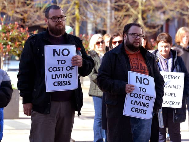 Colr. Doyle and other people hold posters at the Derry Fuel Poverty Rally in Waterloo Place on Sunday afternoon last. Photo: George Sweeney.  DER2213GS – 067