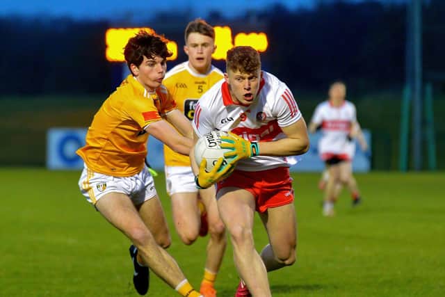 Antrim’s Conall McGirr chases Patrick O’Kane as the Derryman breaks forward at Owenbeg on Friday evening last. Photo: George Sweeney. DER2213GS – 059