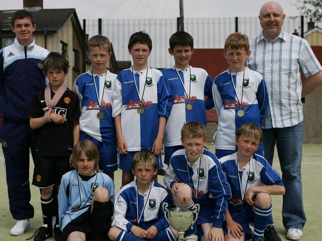 Trench Road PS soccer team, winners of the Whistle Stop Cross Community Primary School soccer competition held at Gobnascale pictured with Michael McCruddan (Newcastle Utd) and tournament sponsor Jimmy Lyons (Nippy Taxis).  (0606JB26)