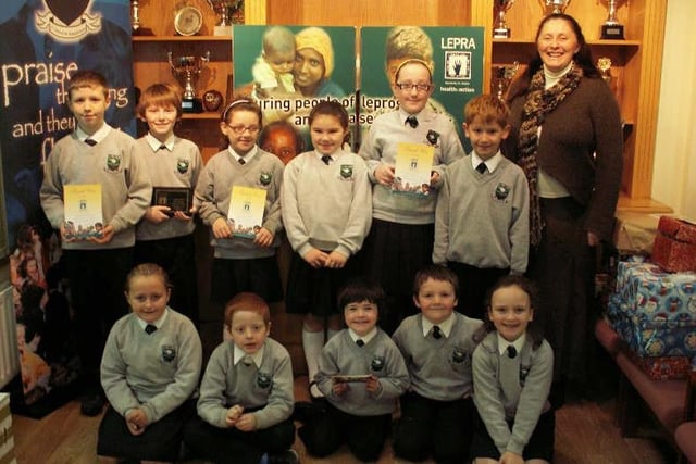 Children from Trench Road PS pictured receiving certificates in recognition of their efforts during the school’s recent LEPRA Workout Challenge which raised more than £1,600.  Included from left at rear are, Ethan Campbell, James McGavigan, Chloe Curran, Louise Hinds, Caitlin Kelly, Christopher McCloskey and Lesley Starrett (LEPRA).  Front, from left are, Sarah Owens, Jack McCafferty, Shea McEvoy, Reece Wason and Aine Donnelly. (2611M2)