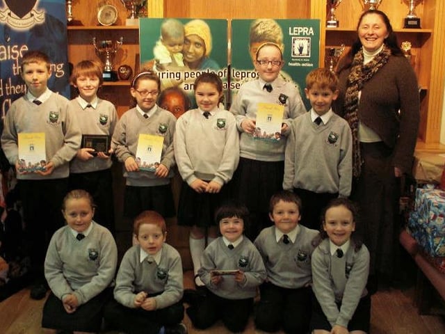 Children from Trench Road PS pictured receiving certificates in recognition of their efforts during the school’s recent LEPRA Workout Challenge which raised more than £1,600.  Included from left at rear are, Ethan Campbell, James McGavigan, Chloe Curran, Louise Hinds, Caitlin Kelly, Christopher McCloskey and Lesley Starrett (LEPRA).  Front, from left are, Sarah Owens, Jack McCafferty, Shea McEvoy, Reece Wason and Aine Donnelly. (2611M2)