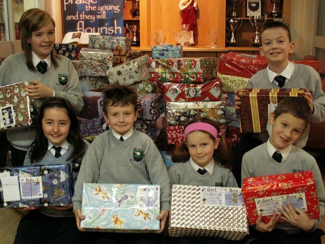 Pupils from Trench Road Primary School, Waterside displaying some of the 250 boxes collected as part of the
school's Road of Hope Christmas Shoebox Appeal. The
boxes will be sent to Bosnia and Croatia to children suffering extreme isolation, poverty and the traumas of war. Pictured, front left are Aoife Fleming, Shea Boyle, Erin McCloskey and Conall McCloskey. Back from left are Kellie McCauley and Anthony McGuigan.