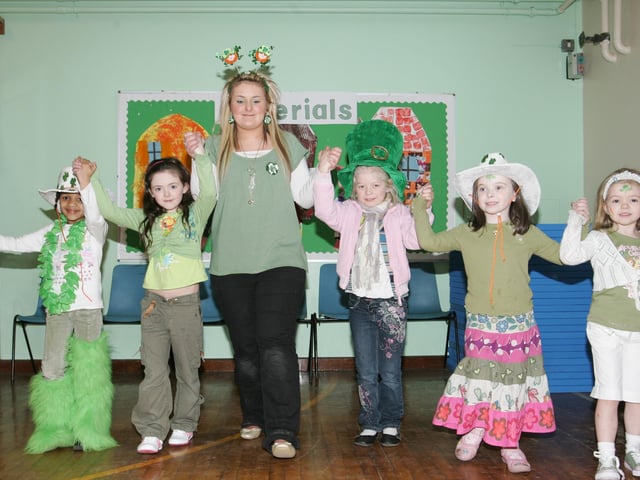 Trench Road PS classroom assistant Roisin Boyle leads children during the charity ceili at the school. (2003JB02)