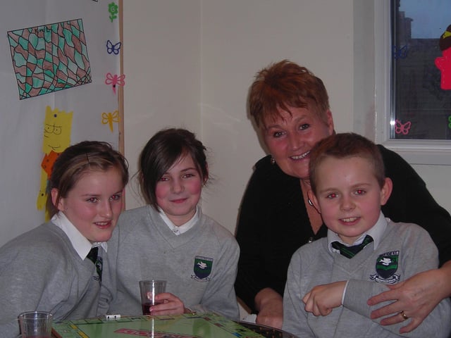 From left - Orlath Barr, 11, Elana Kelly, 10, and Jamie Norris, 10, from Trench Road Primary School, along with homework club officer, Mary McGrath.