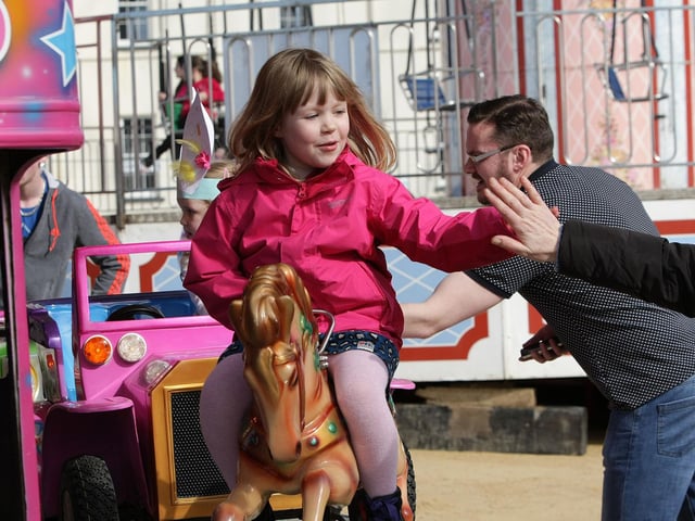 HIGH FIVE!. . . It's a 'High Five' for mum from this young lady, enjoying one of the rides at Cullen's Funfair's on Saturday at Ebrington. DER1315MC084