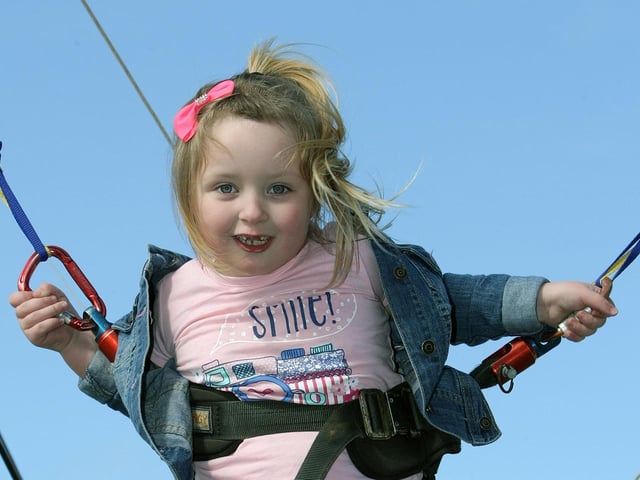 Bungee jumping for this young girl during Saturday's Cullens Funfair at Ebrington. DER1315MC087