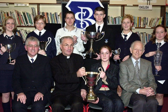 Fr. Aidan Mullan, P.P., Waterside, presenting the Desmond Cup for Academic Excellence to Tracey McCay. Included at front are Mr. Paul Molloy, principal, and Mr. Joe Fagan, board of governors. Back, from left, are Deborah McFadden (Civic Award), Michelle McGowan (Community Service), James Boyle (Contribution to School Life), Martin Starrett (Most Committed Student), Sheila Kerrigan (Work Experience Cup) and Claire O'Kane (Best Work Experience). (1/12/CD11)