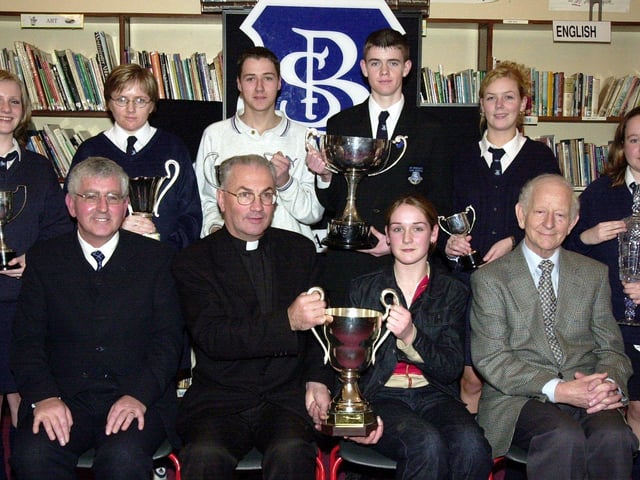 Fr. Aidan Mullan, P.P., Waterside, presenting the Desmond Cup for Academic Excellence to Tracey McCay. Included at front are Mr. Paul Molloy, principal, and Mr. Joe Fagan, board of governors. Back, from left, are Deborah McFadden (Civic Award), Michelle McGowan (Community Service), James Boyle (Contribution to School Life), Martin Starrett (Most Committed Student), Sheila Kerrigan (Work Experience Cup) and Claire O'Kane (Best Work Experience). (1/12/CD11)