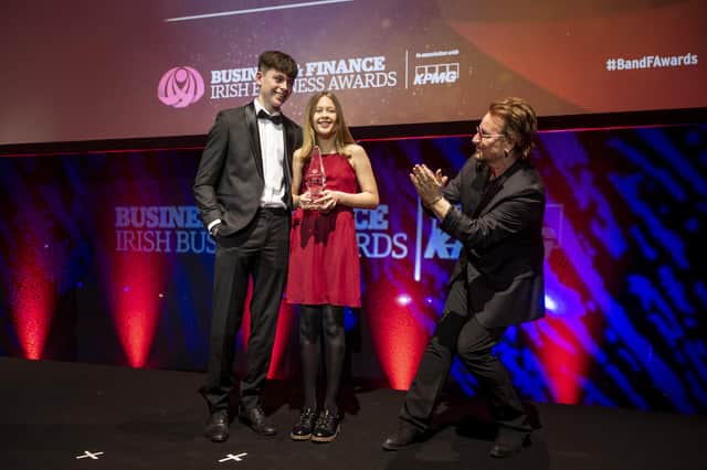 The Grandchildren of the late John Hume, Rachel (13) and Ollie (16) receiving applause from surprise guest Bono as they accept the TK Whitaker Award for Outstanding Contribution to Public Life on behalf of their late grandparents John and Pat Hume at the 47th annual Business & Finance Awards, in association with KPMG, took place at Dublin's Convention Centre. Picture Andres Poveda