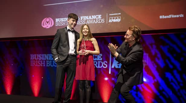 The Grandchildren of the late John Hume, Rachel (13) and Ollie (16) receiving applause from surprise guest Bono as they accept the TK Whitaker Award for Outstanding Contribution to Public Life on behalf of their late grandparents John and Pat Hume at the 47th annual Business & Finance Awards, in association with KPMG, took place at Dublin's Convention Centre.  Picture Andres Poveda