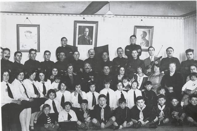 In the 1930s, Derry’s Italian community formed itself into a Fascistii, the men of which were known as Black Shirts. On the wall, in the centre, is a photo of Il Duce, Benito Mussolini, flanked by portraits of the King and Queen of Italy. The man not in uniform holding the violin is Orlando Cafolla, the well-known musician and teacher. (Bigger and McDonald Collection)