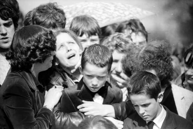 Maria McConomy with her sons Emmett and Mark at the funeral of her 11-year-old boy Stephen who was killed by a British soldier on April 16, 1982.