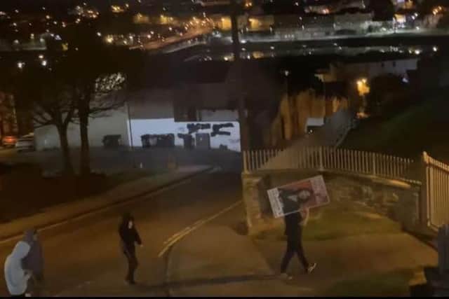 An image showing Sinéad McLaughlin's poster being removed last night.