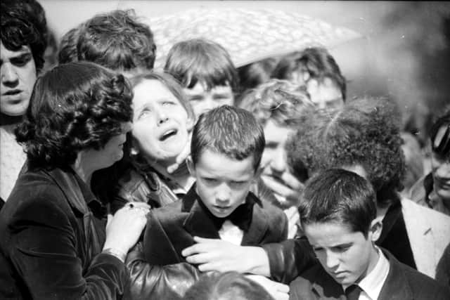 Maria McConomy with her sons Emmett and Mark at the funeral of her 11-year-old boy Stephen who was killed by a British soldier on April 16, 1982.