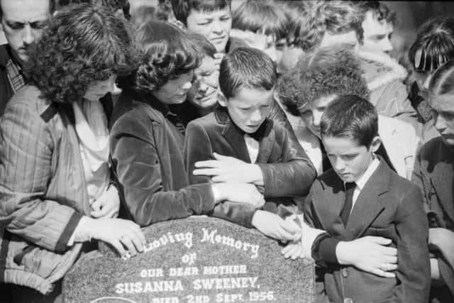 Stephen’s mother Maria comforting her other sons Mark and Emmett at the interment in the City Cemetery.