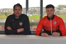 Derry City manager Ruaidhri Higgins sits alongside Cameron McJannet, as the defender signs his new contract extension. Picture by George Sweeney