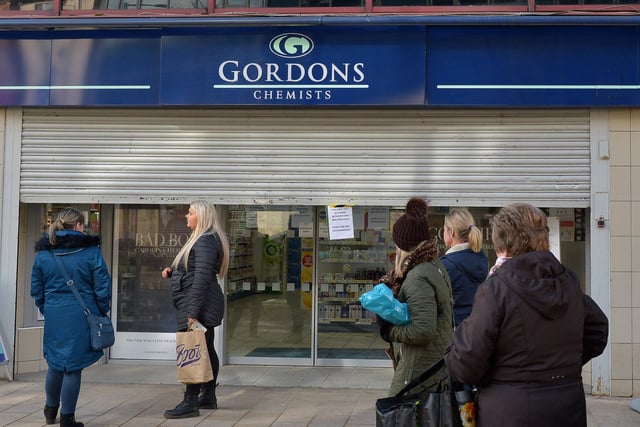 People waiting for Gordons Chemist, on Strand Road, to open after lunch time on Wednesday afternoon last. DER1220GS - 027