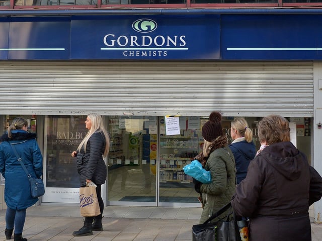 People waiting for Gordons Chemist, on Strand Road, to open after lunch time on Wednesday afternoon last. DER1220GS - 027