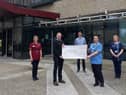 Conor Nichol, who raised £1,800 for the North West Cancer Centre by running 101 miles in one month. Conor made the presentation to NWCC staff Sinead Molloy, Dr McNicholl, Una O’Hara and Leanne Brandon.