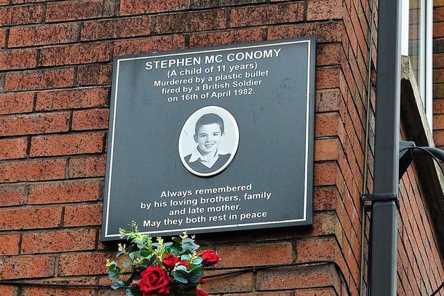 A plaque and flowers in Fahan Street mark the place where 11 year old Stephen McConomy was killed by a plastic bullet on 16th April 1982. Photo: George Sweeney. DER2215GS – 072