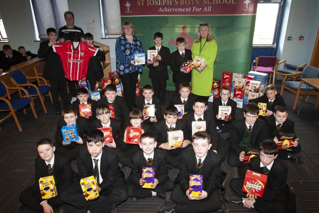 EASTER EGGS. . . . .Year 8 students from St. Josephâ€TMs Boys School pictured on Wednesday last with their Easter eggs, received for all their hard work in raising funds for Trocaire over the six week lenten period. Included are back left are Mr. Dan Maud with Kai Connelly and Coran McCauley and a Derry City signed football shirt, part of the Easter raffle to help raise money. Centre at back is Mrs. Martina McCarron, Principal and Mrs. Ciara Deane, Vice Principal, handing over Easter eggs to Logan White and Shay Bogle. (Photos: Jim McCafferty Photography)