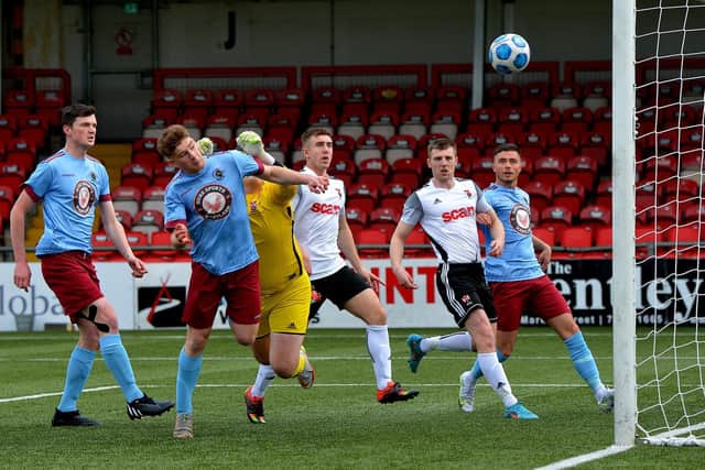 Mark McFadden heads home Institute’s first the goal against Queen's University. Picture by George Sweeney.