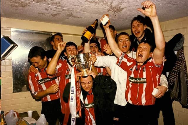 Derry City players and fans (left to right) Liam Coyle, Declan Devine, Declan Boyle, John Pio O’Doherty (Life-long supporter), Peter Hutton, Tony O'Dowd, Tom Mohan and Tommy Dunne, celebrate in the changing room after their 1997 title glory.