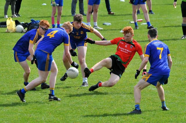 Doire Trasna's Adam McGuinness finds himself out-numbered against Naomh Padraig Muff in the annual Corn na bhFiann U17s Sevens at Corrody Road on Easter Saturday. Photo: George Sweeney. DER2215GS – 052