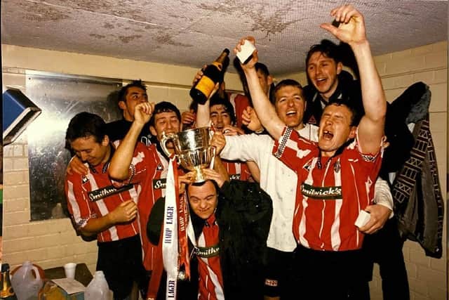 Derry City players and fans (left to right) Liam Coyle, Declan Devine, Declan Boyle, John Pio O’Doherty (Life-long supporter), Peter Hutton, Tony O’Dowd, Tom Mohan and Tommy Dunne, celebrate in the changing room after their 1997 title glory.