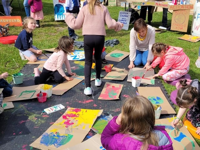 Young people working hard on their placards at the festival.