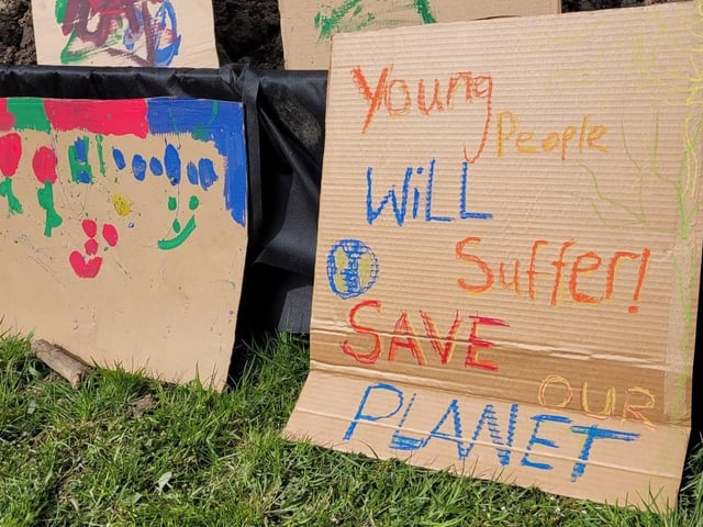 A placard urging people to save the planet.